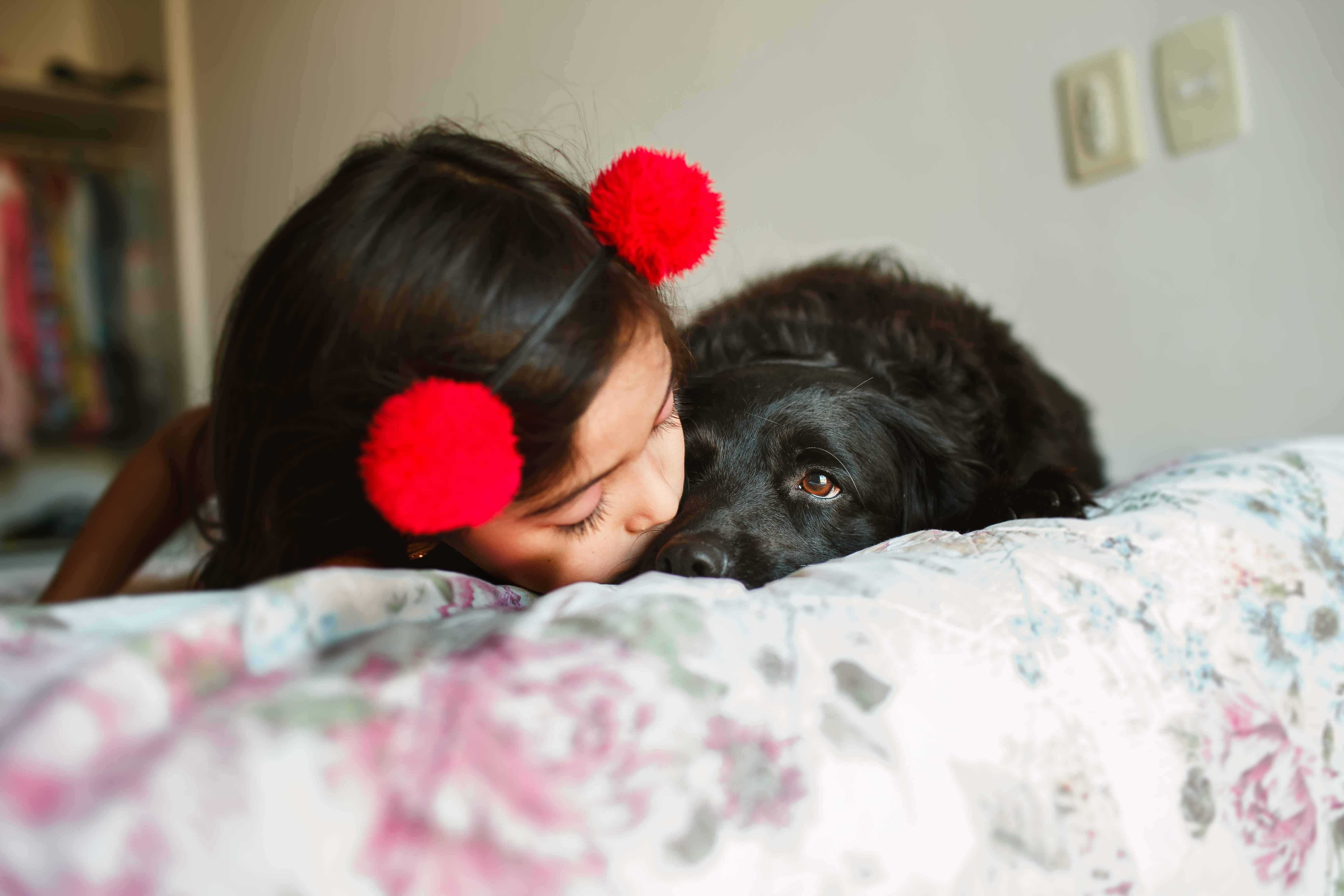 Girl with a dog on bed